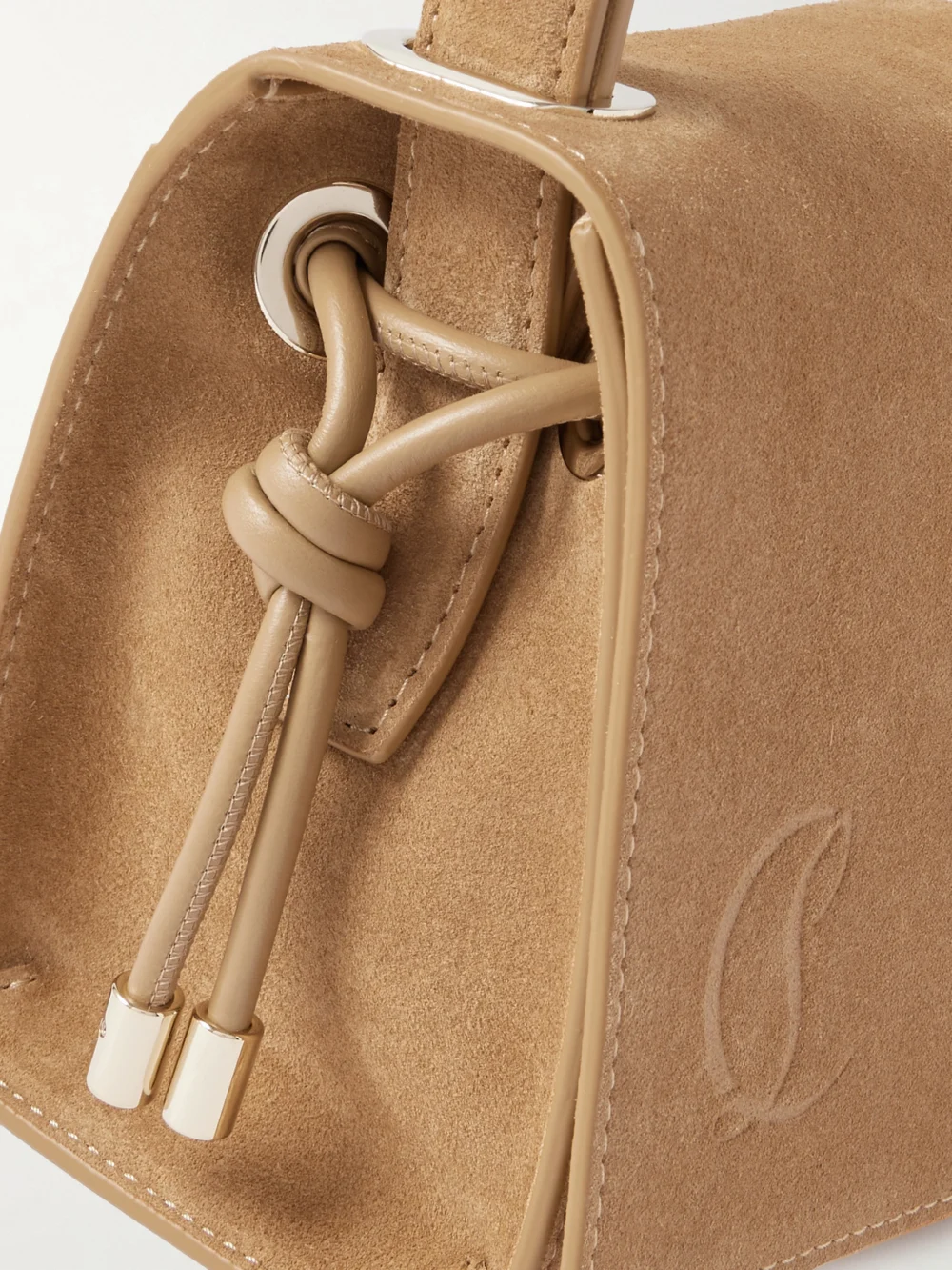Close-up detail of the Christian Louboutin Baggy Small Logo-debossed Suede Shoulder Bag