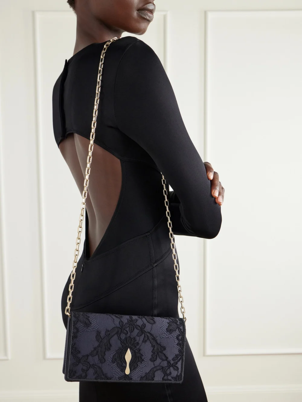 Close-up detail of the Christian Louboutin Bettina Lace-trimmed Satin Clutch