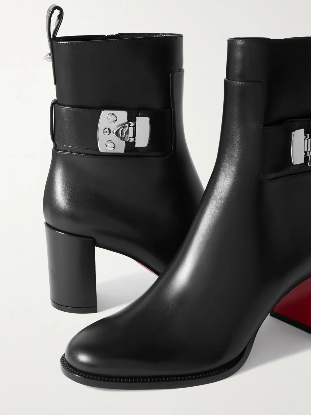 Close-up detail of the Christian Louboutin Booty Lock 70 Embellished Leather Ankle Boots