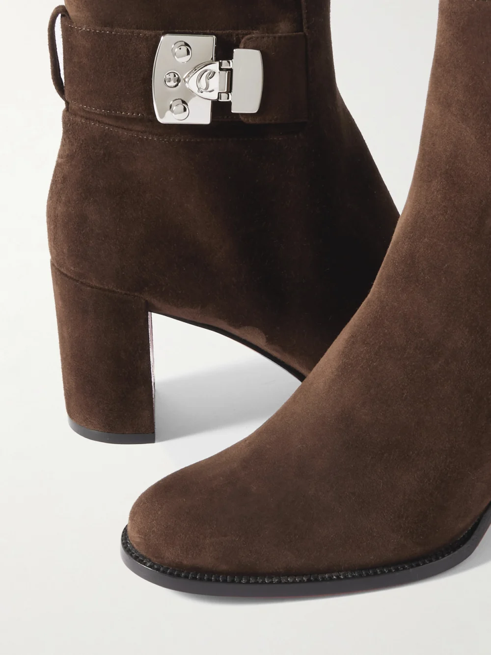 Close-up detail of the Christian Louboutin Booty Lock 70 Embellished Suede Ankle Boots