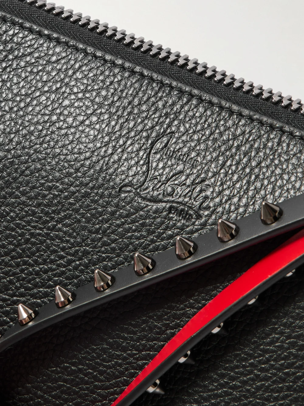Close-up detail of the Christian Louboutin Cabata Studded Textured-leather Clutch
