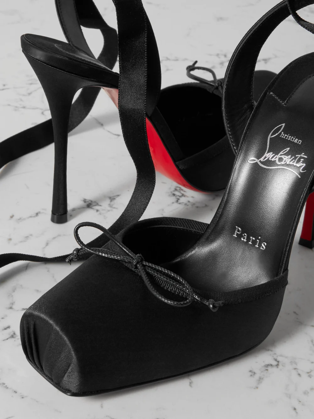 Close-up detail of the Christian Louboutin Cassia 100 Bow-detailed Grosgrain-trimmed Satin-crepe Pumps