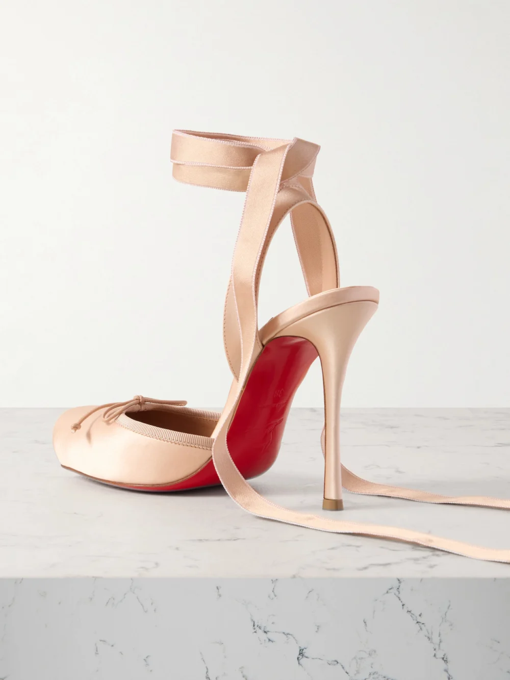 Back view of the Christian Louboutin Cassia 100 Bow-detailed Satin-crepe Pumps
