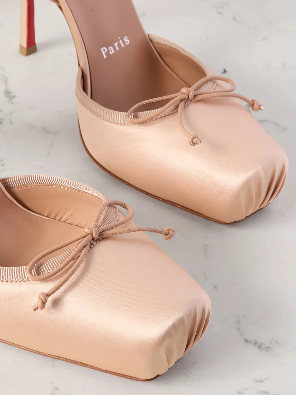Close-up detail of the Christian Louboutin Cassia 100 Bow-detailed Satin-crepe Pumps