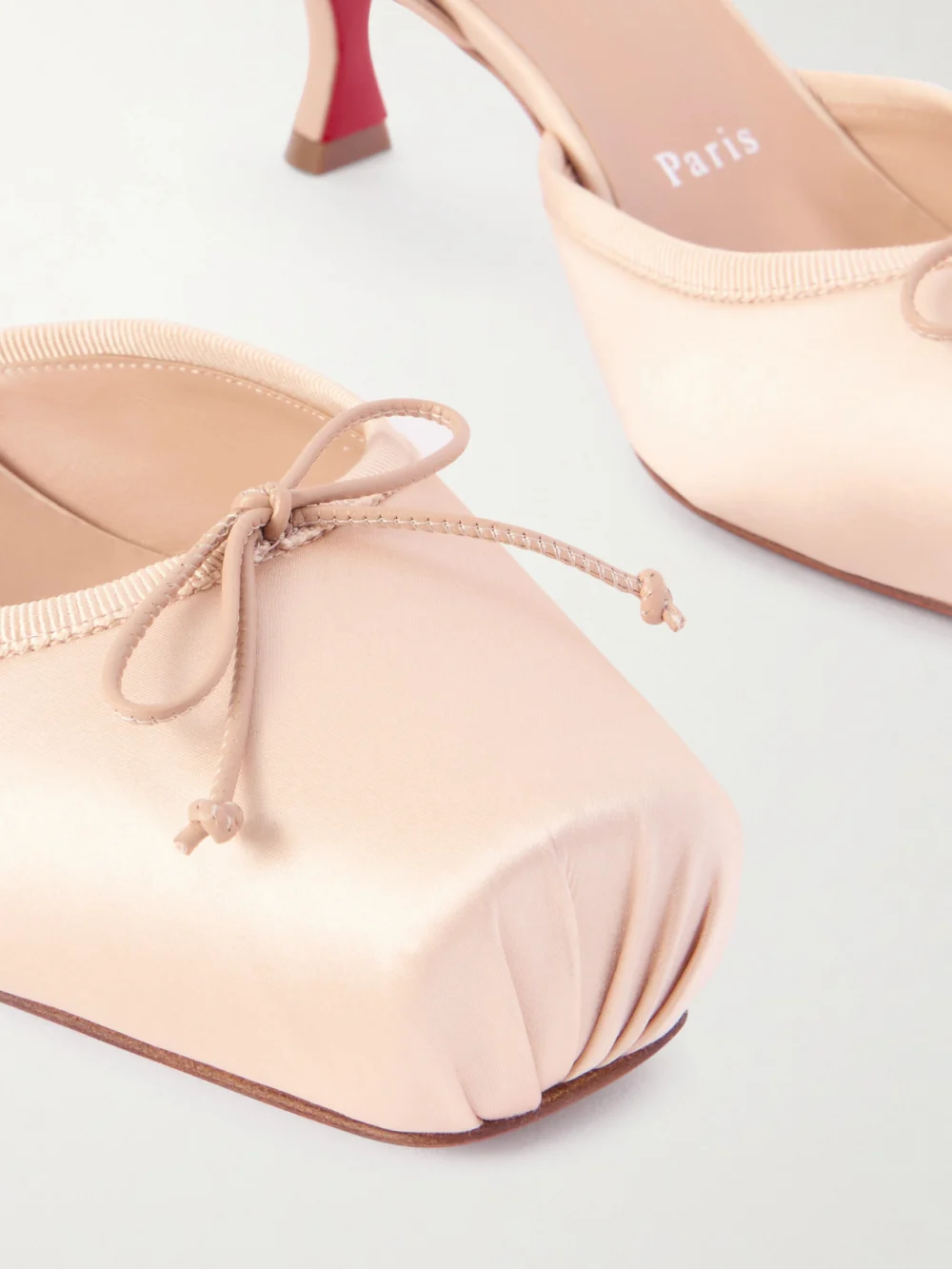 Close-up detail of the Christian Louboutin Cassia 55 Bow-detailed Grosgrain-trimmed Satin Pumps