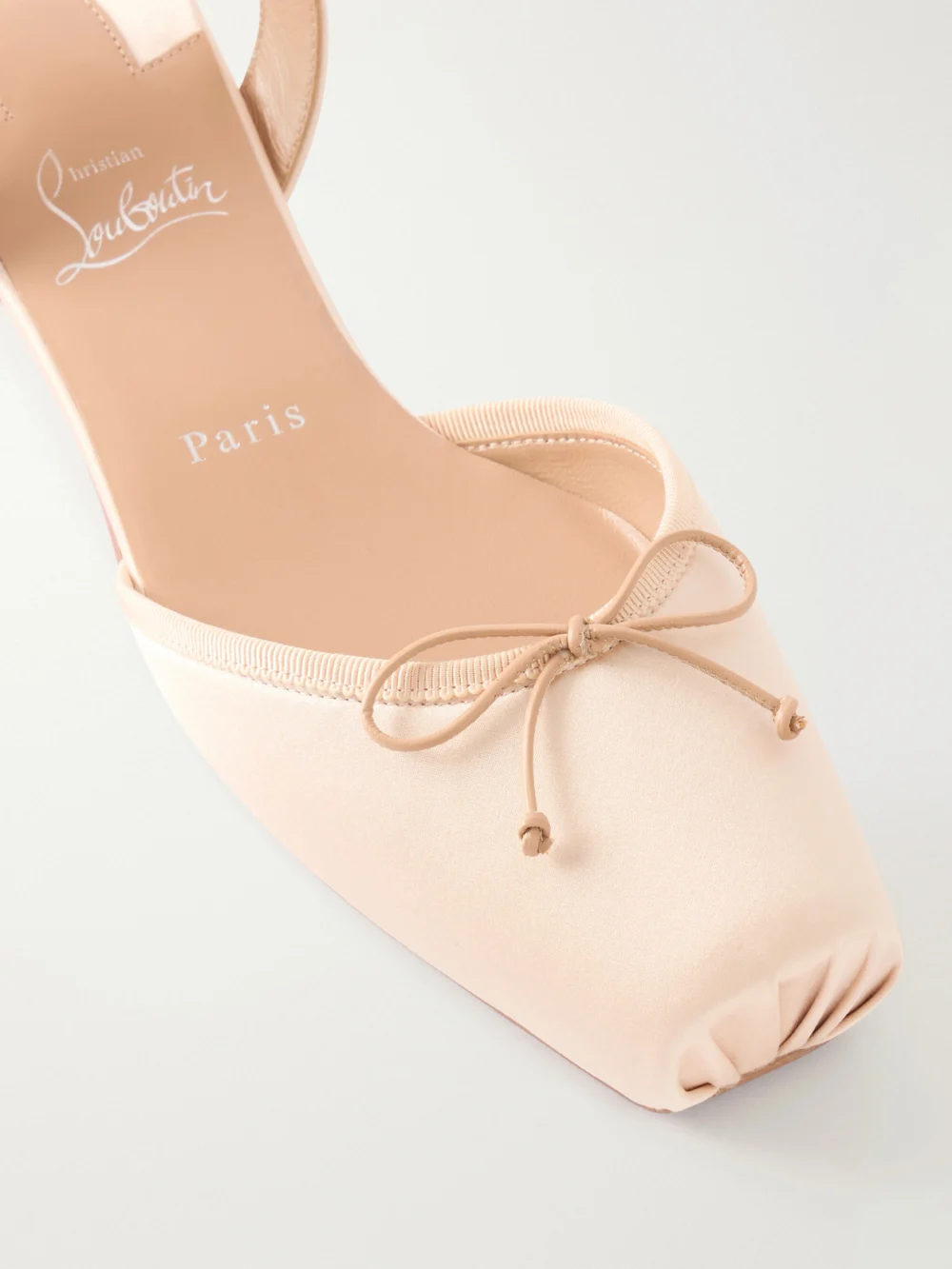 Close-up detail of the Christian Louboutin Cassia Bow-detailed Grosgrain-trimmed Satin Flats