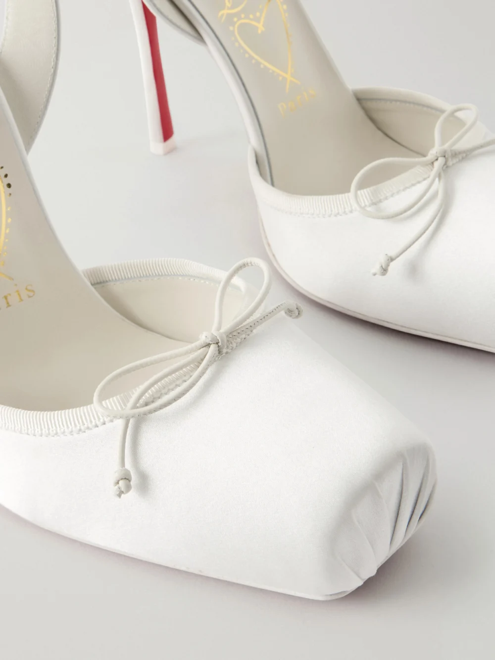 Close-up detail of the Christian Louboutin Cassia Lace Up 100 Crepe Satin Squared Toe Ballerina Pump