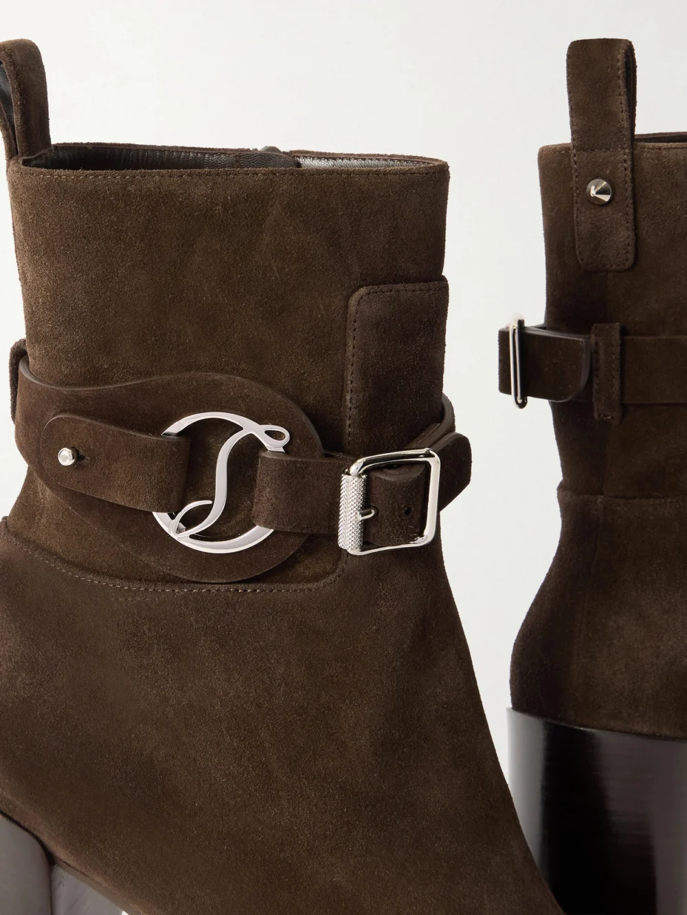 Close-up detail of the Christian Louboutin Dianouchette 100 Buckled Suede Ankle Boots