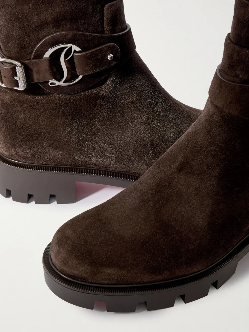 Close-up detail of the Christian Louboutin Dianouchette Buckled Suede Ankle Boots