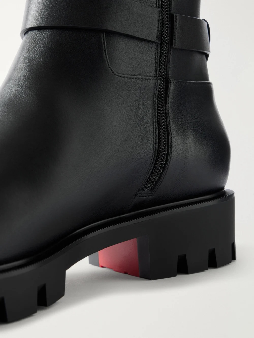 Close-up detail of the Christian Louboutin Dianouchette Lug Buckled Leather Knee Boots