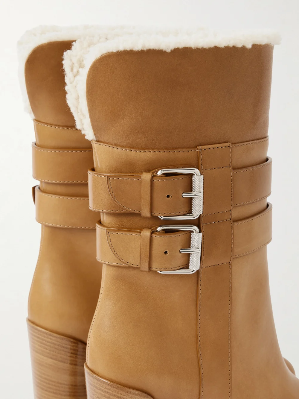 Close-up detail of the Christian Louboutin Elisawalk 100 Buckled Shearling-lined Leather Ankle Boots