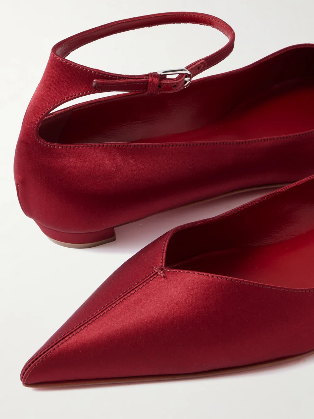 Close-up detail of the Christian Louboutin Erozeena Satin Point-toe Flats