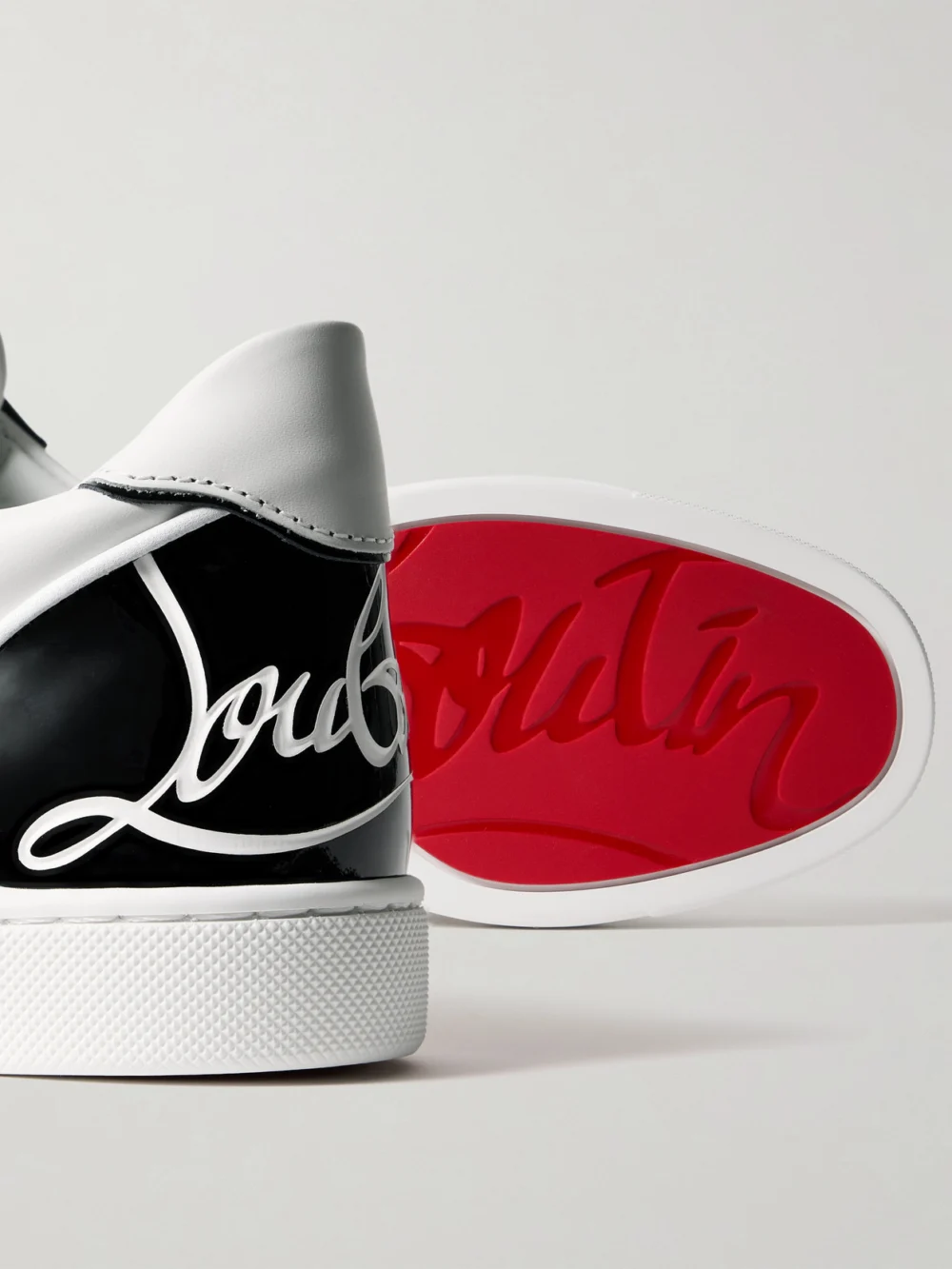 Close-up detail of the Christian Louboutin Fun Vieira Patent-leather Trimmed Leather Sneakers