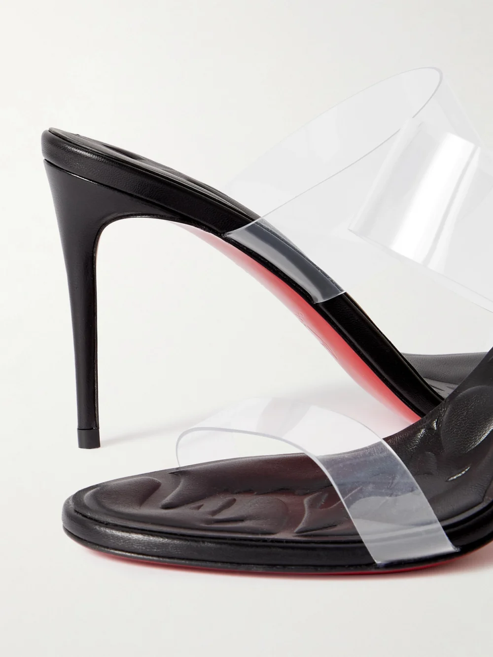 Close-up detail of the Christian Louboutin Just Loubi 85 Pvc Mules