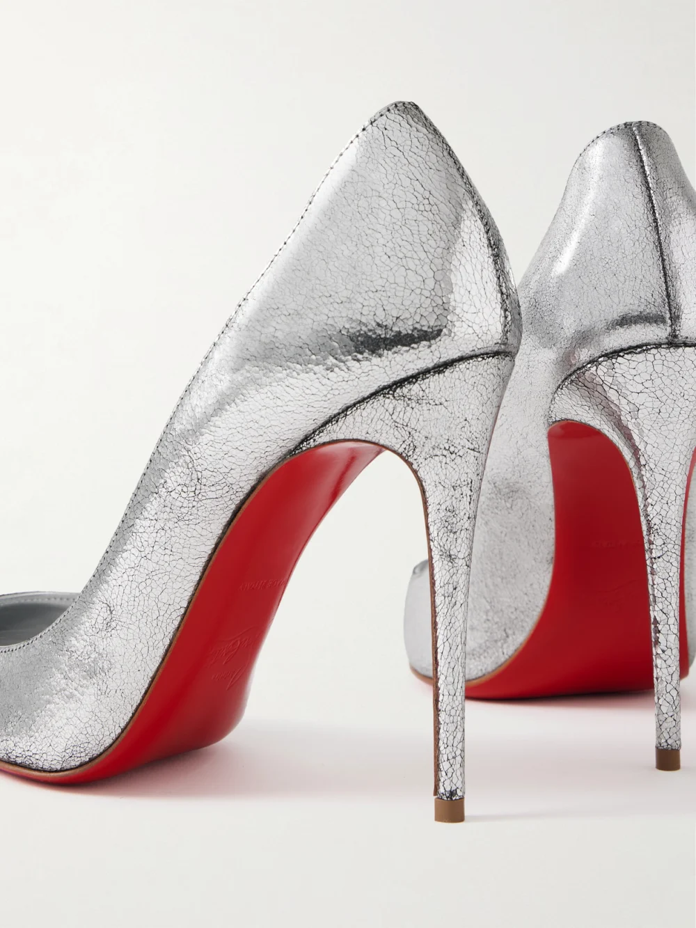 Close-up detail of the Christian Louboutin Kate 100 Metallic Cracked-leather Pumps