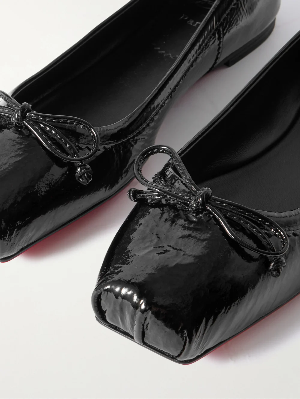 Close-up detail of the Christian Louboutin Mamadrague Crinkled Patent-leather Ballet Flats