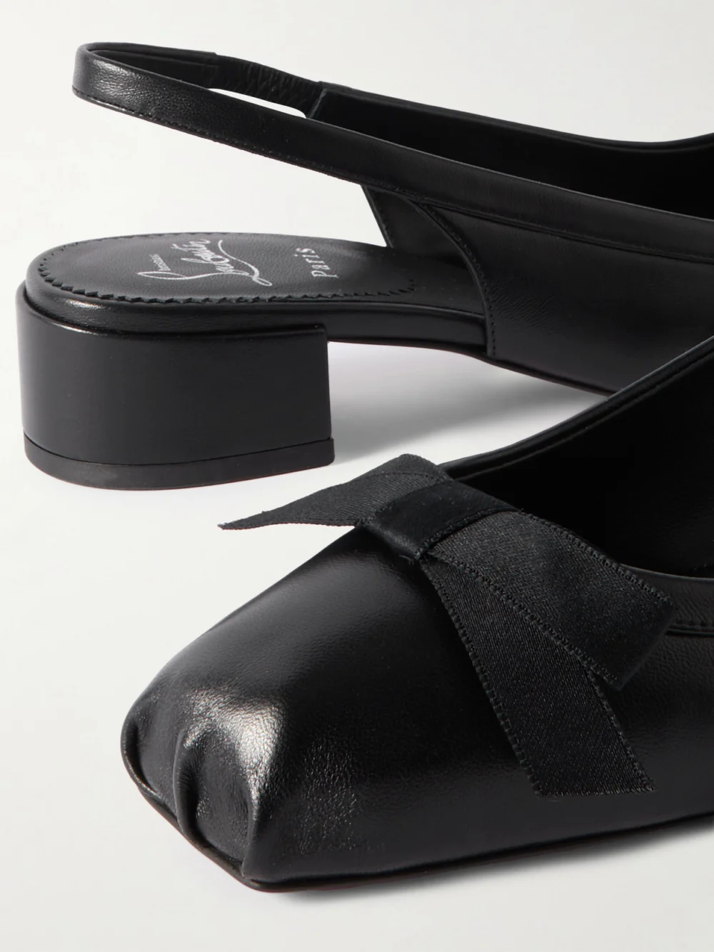Close-up detail of the Christian Louboutin Mamaflirt 30 Bow-embellished Leather Slingback Pumps