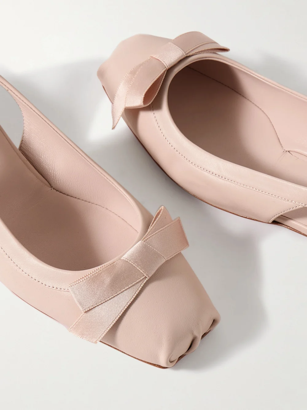 Close-up detail of the Christian Louboutin Mamaflirt 30 Bow-embellished Leather Slingback Pumps