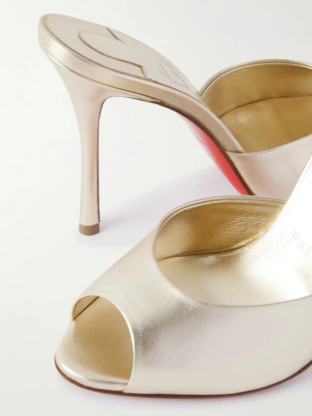 Close-up detail of the Christian Louboutin Me Dolly 100 Metallic Leather Mules