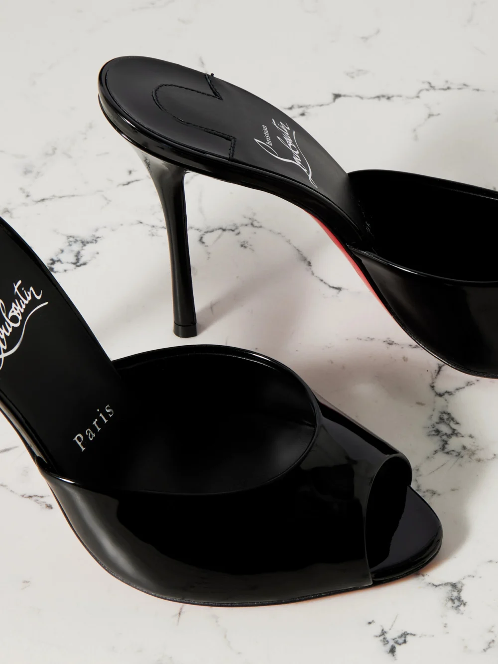 Close-up detail of the Christian Louboutin Me Dolly 100 Patent-leather Mules