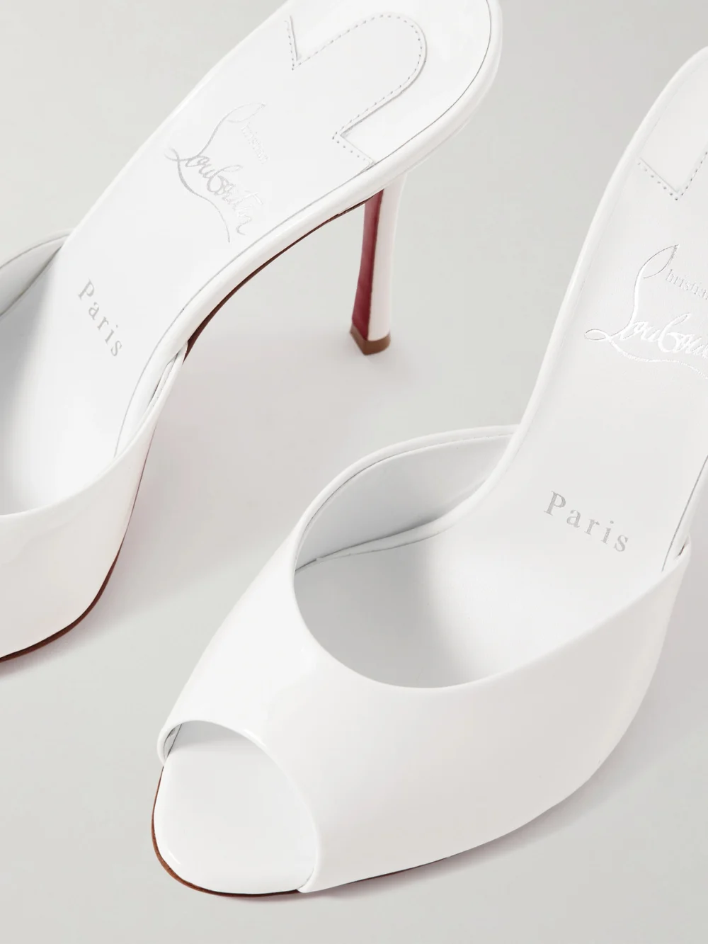 Close-up detail of the Christian Louboutin Me Dolly 100 Patent-leather Mules