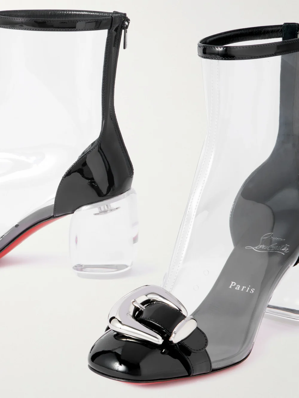 Close-up detail of the Christian Louboutin Minny Bubble Patent Leather-trimmed Pvc Ankle Boots