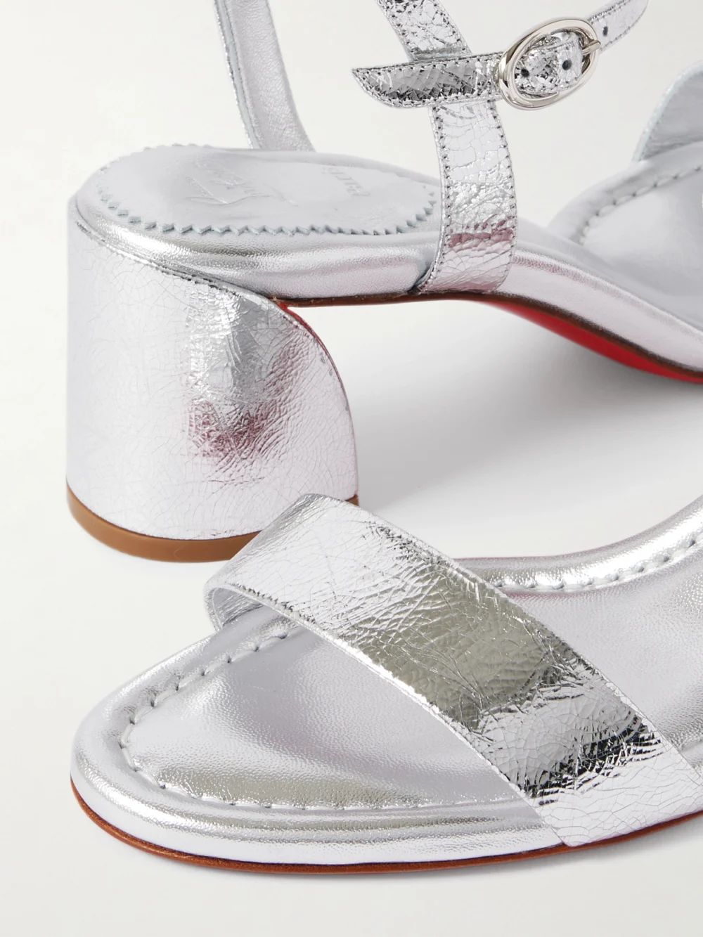 Close-up detail of the Christian Louboutin Miss Jane 55 Metallic Textured-leather Sandals