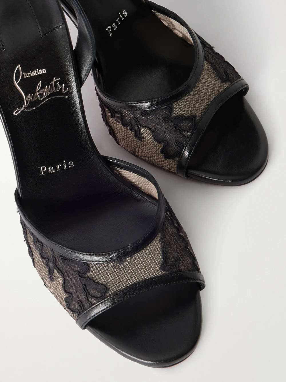 Close-up detail of the Christian Louboutin Miss Z 100 Lace and Leather Slingback Sandals