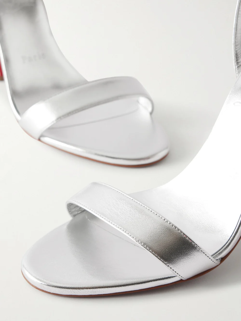 Close-up detail of the Christian Louboutin Miss Z 100 Metallic Leather Sandals