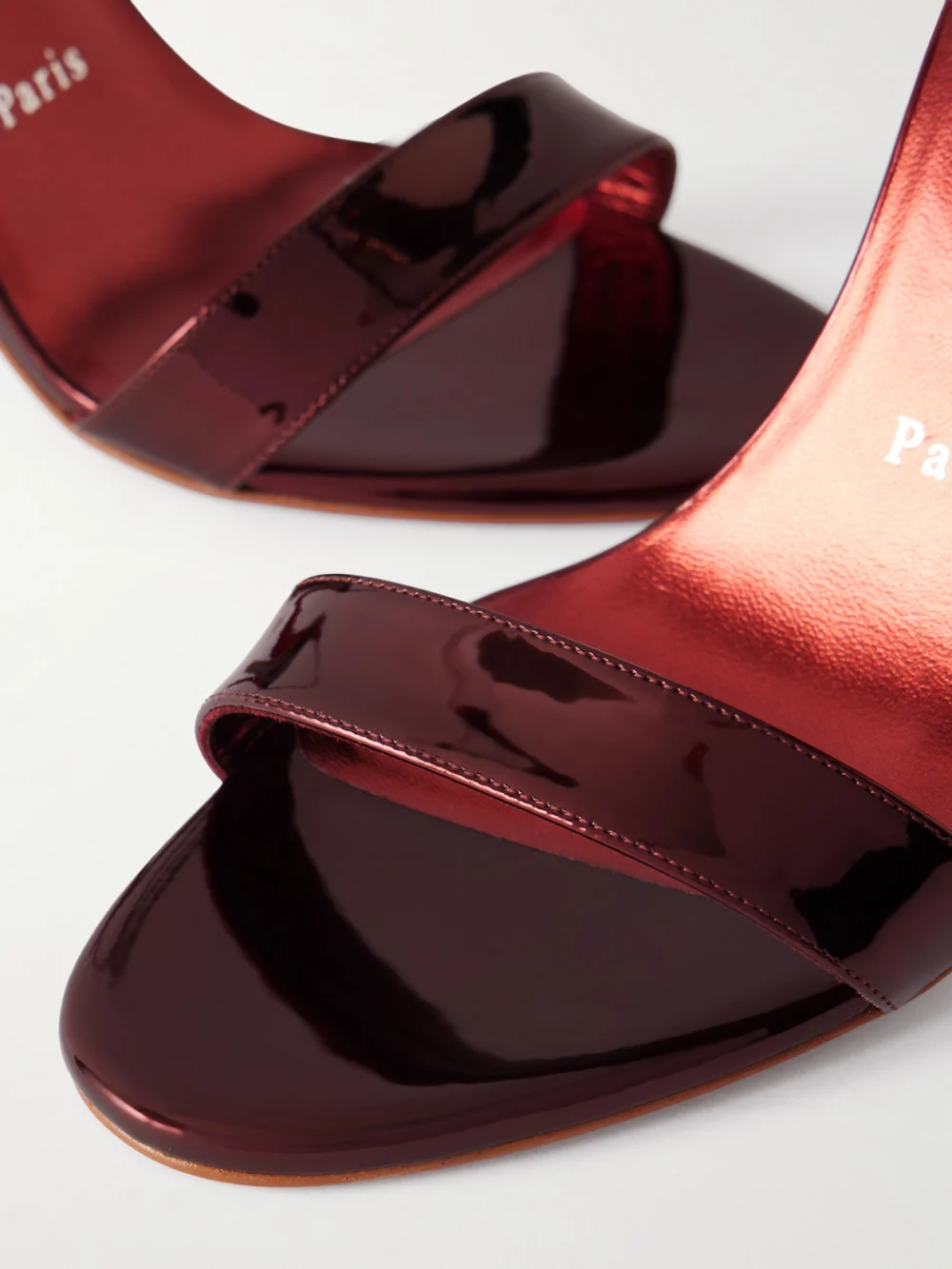 Close-up detail of the Christian Louboutin Miss Z 100 Metallic Patent Leather Sandals