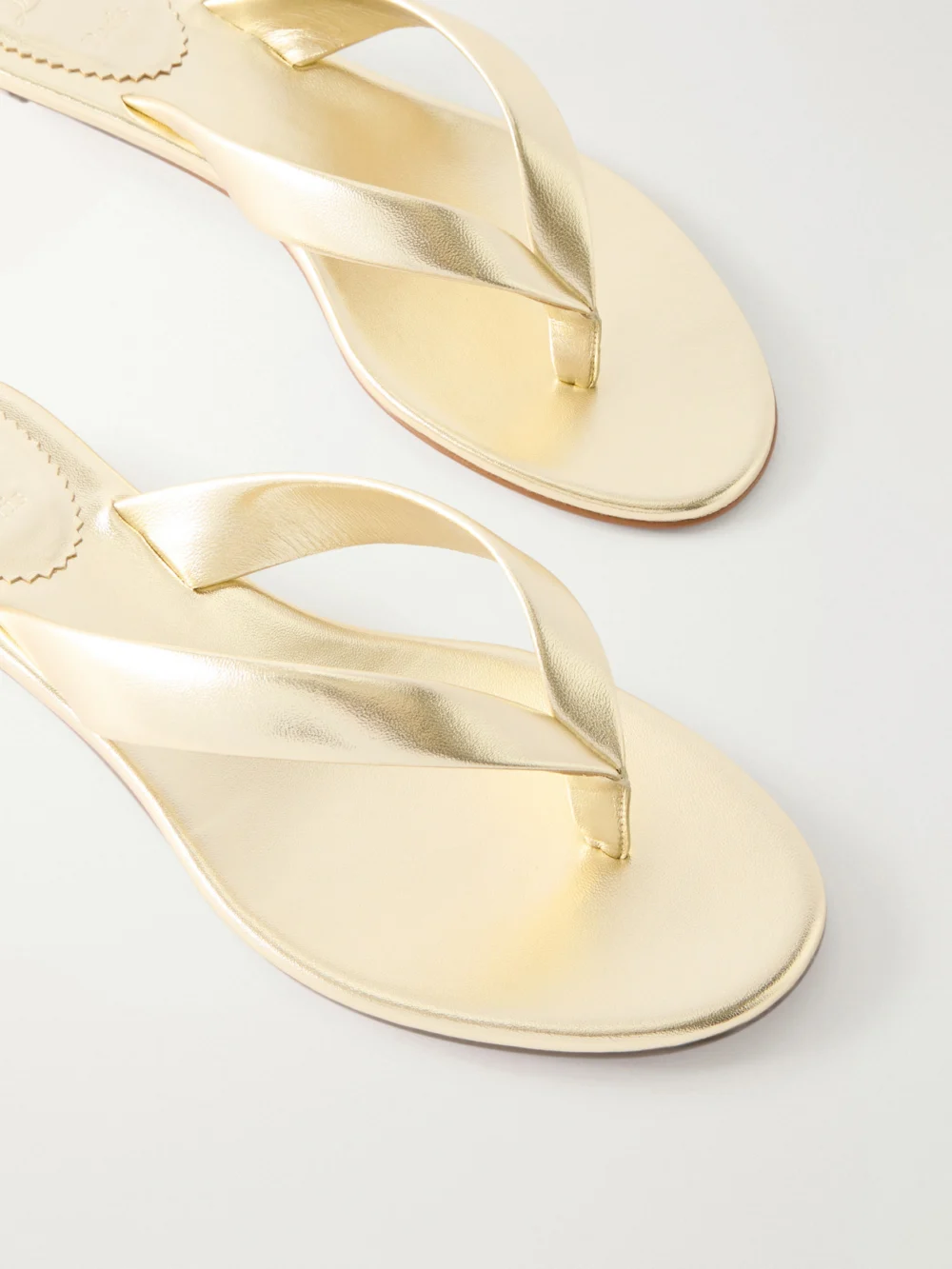 Close-up detail of the Christian Louboutin Miss Z Metallic Leather Thong Sandals