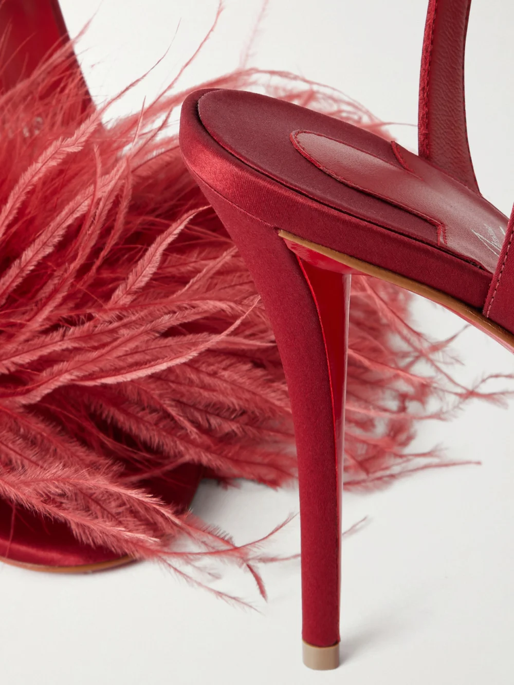 Close-up detail of the Christian Louboutin Miss Z Poupi 100 Feather-embellished Satin Sandals