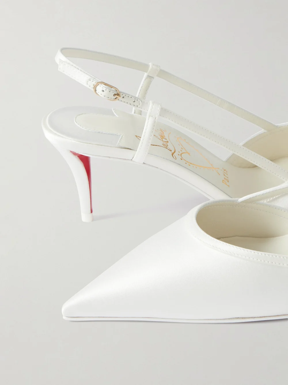 Close-up detail of the Christian Louboutin Miss Z Sling 60 Leather-trimmed Satin Slingback Pumps