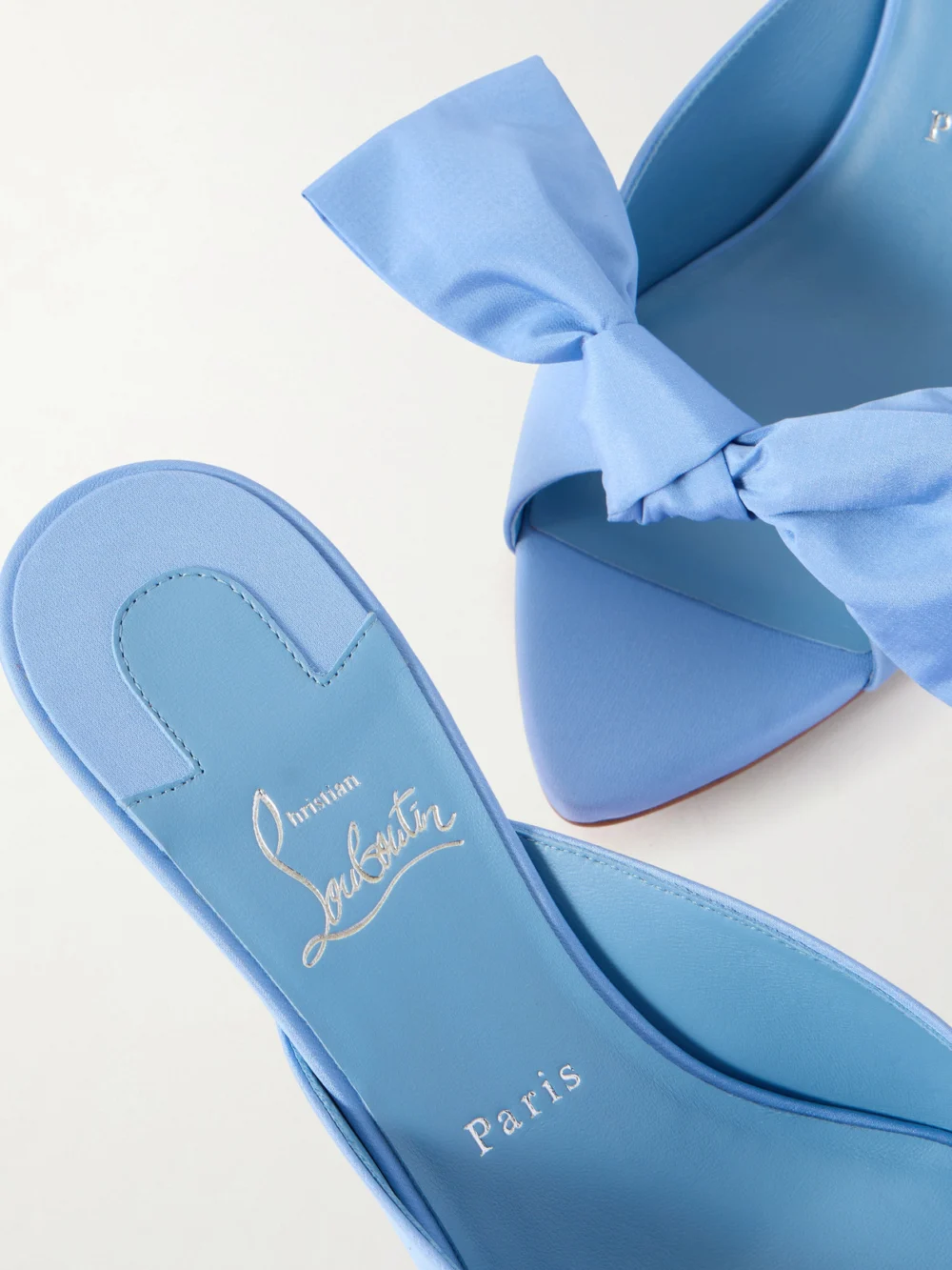 Close-up detail of the Christian Louboutin Mulazee Bow-embellished Crepe De Chine Mules