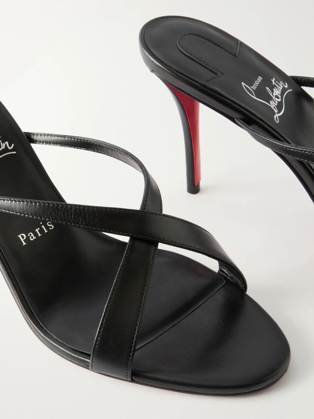 Close-up detail of the Christian Louboutin Mulazee Cross 80 Leather Mules