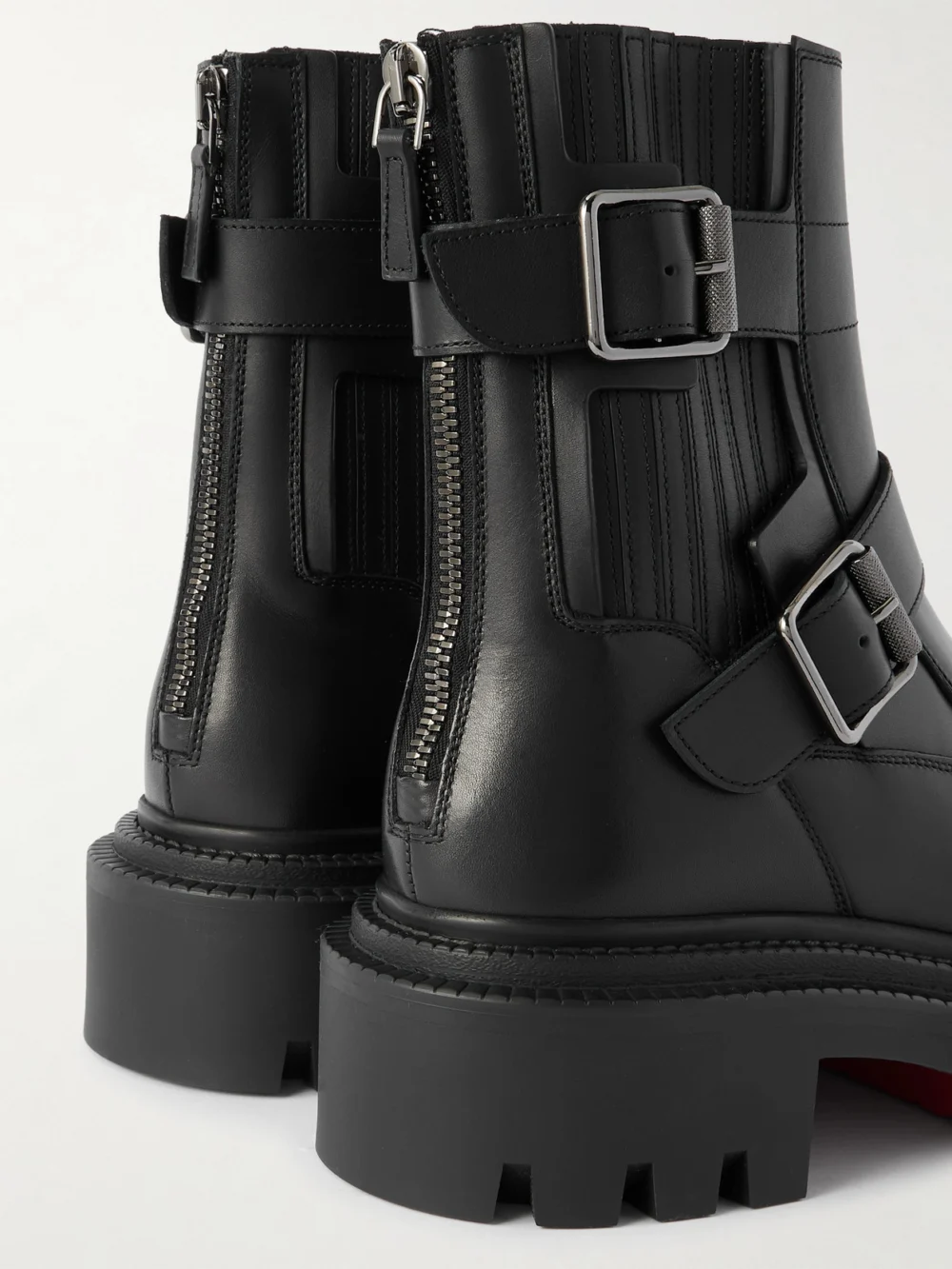 Close-up detail of the Christian Louboutin Oxybootie Buckled Leather Ankle Boots