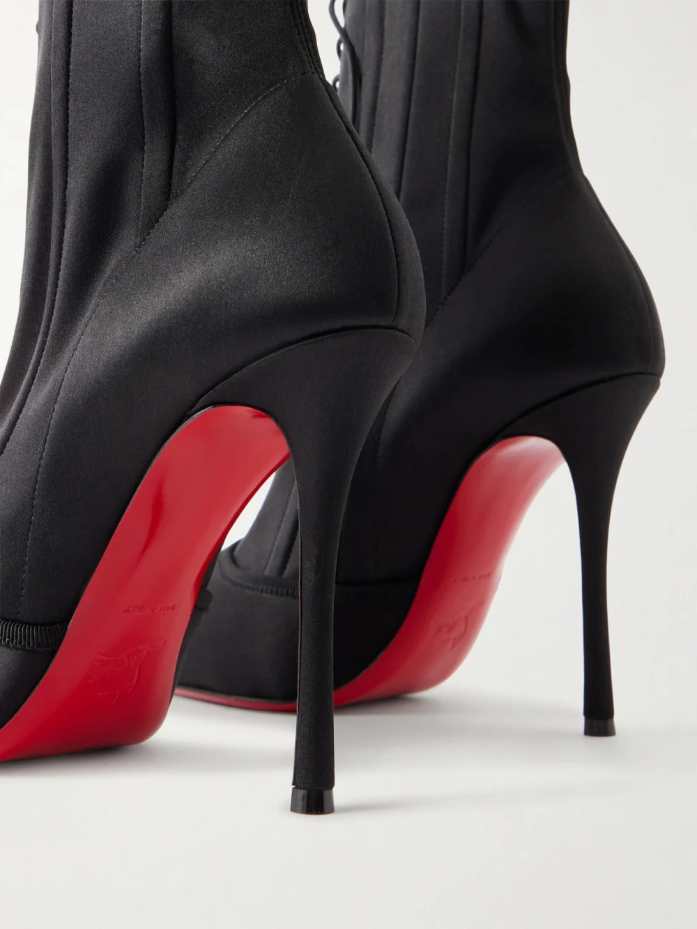 Close-up detail of the Christian Louboutin Pavlova 100 Lace-up Satin Ankle Boots