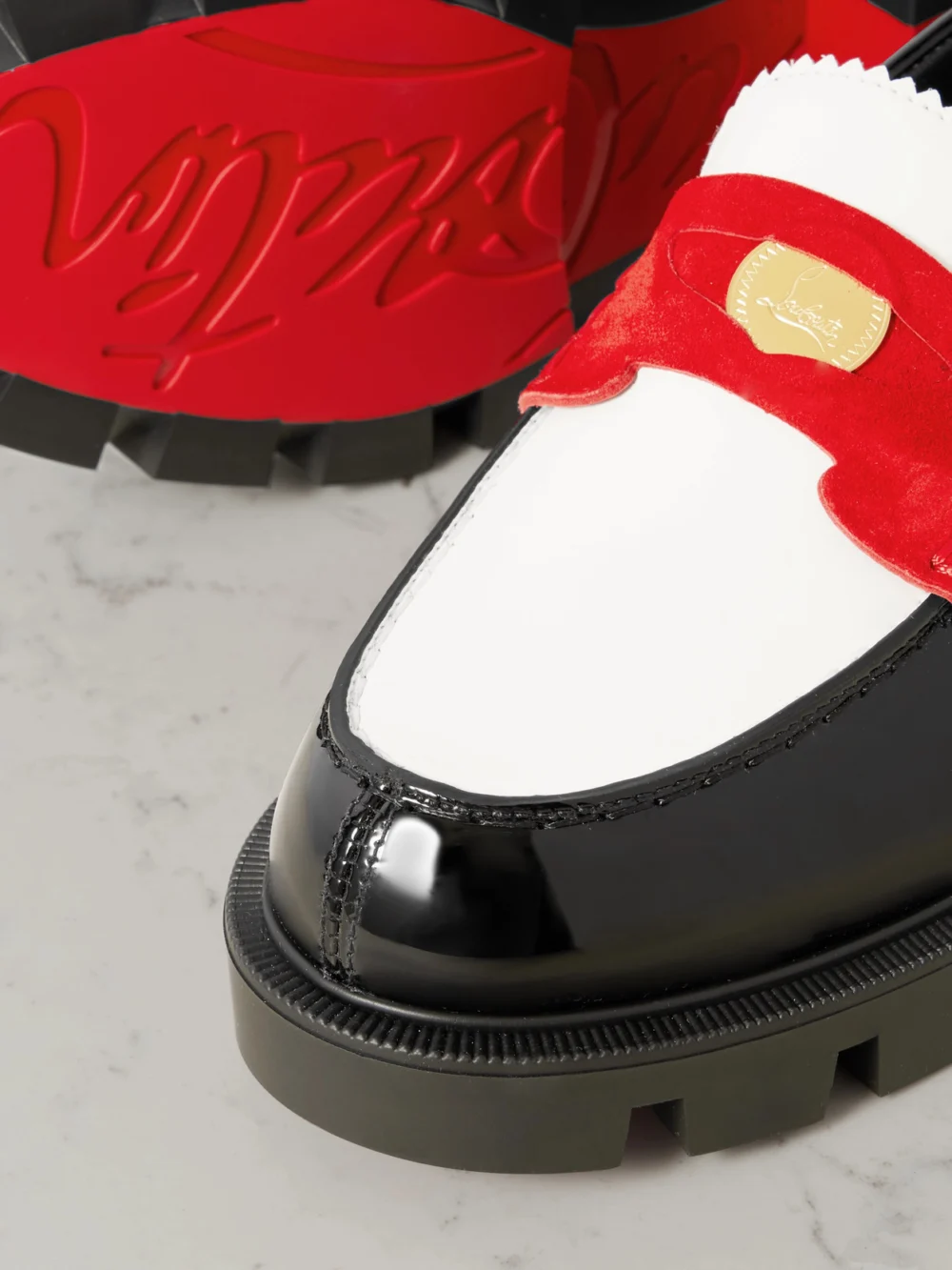 Close-up detail of the Christian Louboutin Penny Velour-trimmed Leather Loafers