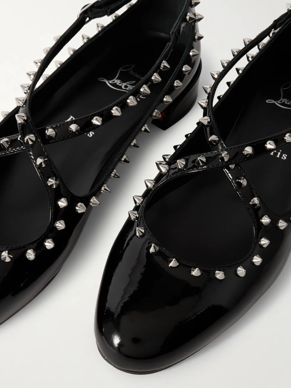 Close-up detail of the Christian Louboutin Pilouta Jane Spike Studded Patent-leather Ballet Flats