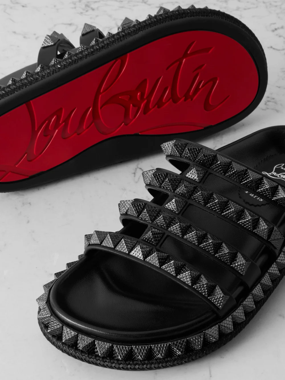 Close-up detail of the Christian Louboutin Pyra Hallulila Studded Leather Sandals
