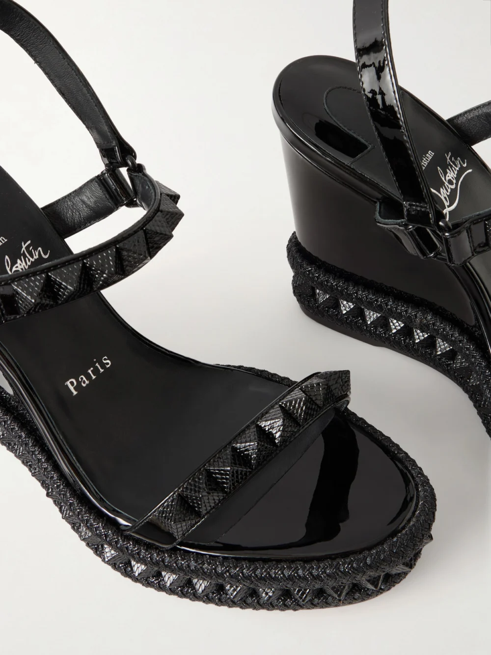 Close-up detail of the Christian Louboutin Pyraclou 110 Studded Leather Wedge Sandals