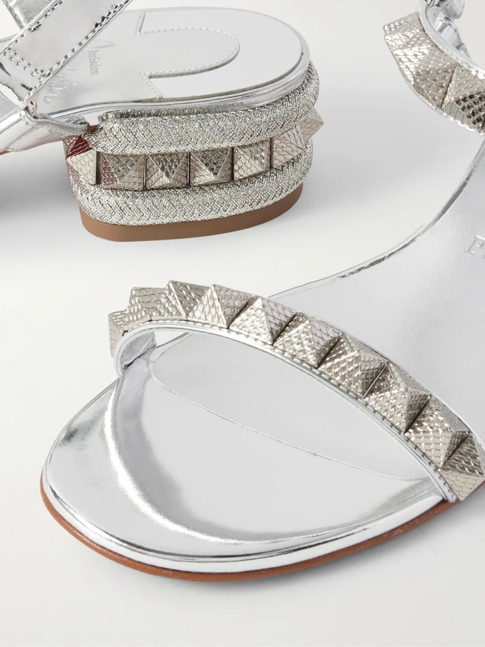 Close-up detail of the Christian Louboutin Pyrasand 30 Studded Mirrored-leather Sandals