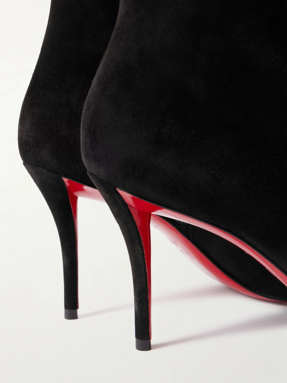 Close-up detail of the Christian Louboutin So Apostropha 80 Suede Ankle Boots