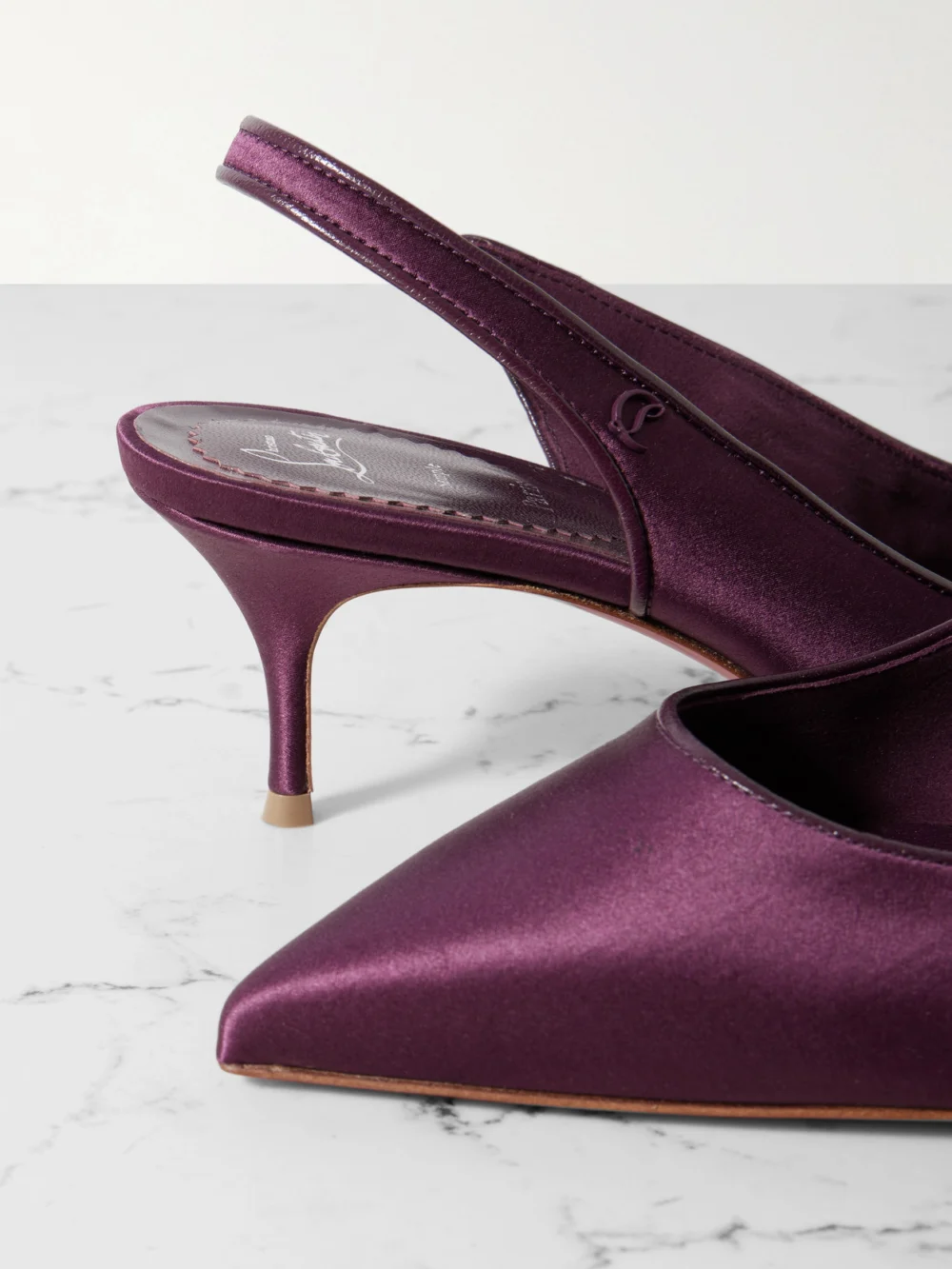Close-up detail of the Christian Louboutin Sporty Kate 55 Satin-crepe Slingback Pumps