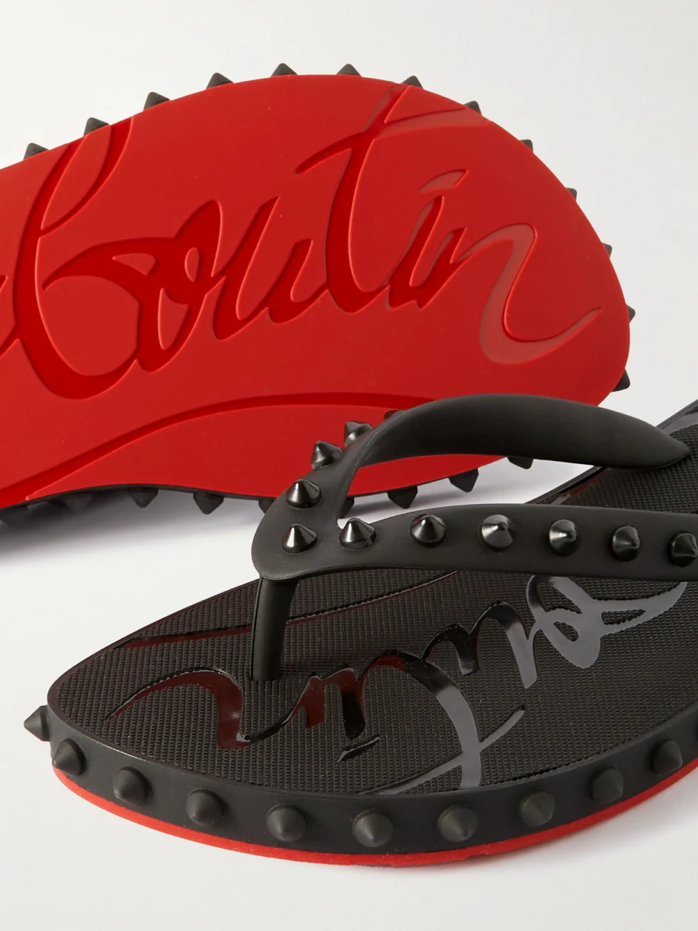 Close-up detail of the Christian Louboutin Super Loubi Studded Rubber Flip Flops