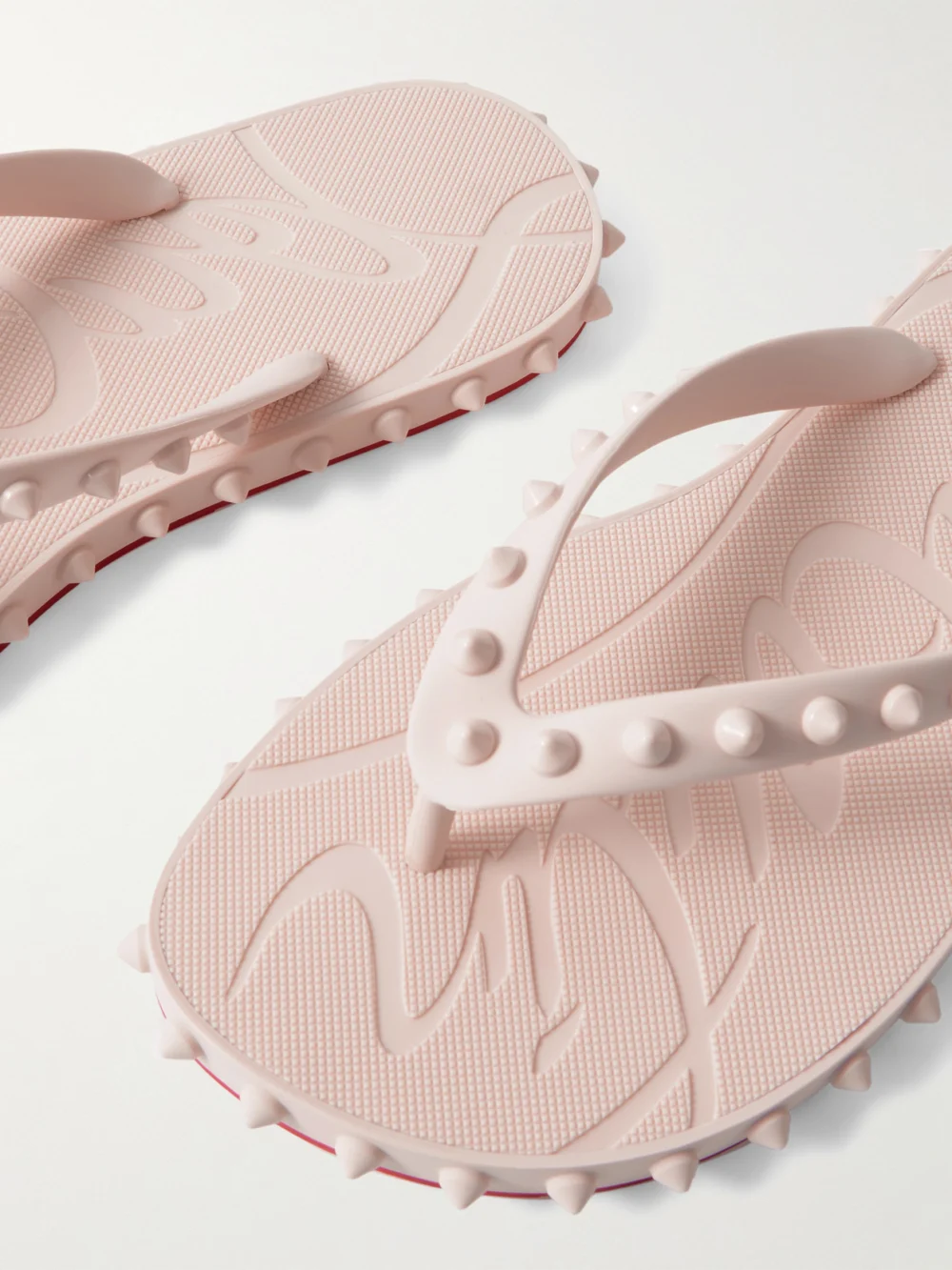 Close-up detail of the Christian Louboutin Super Loubi Studded Rubber Flip Flops
