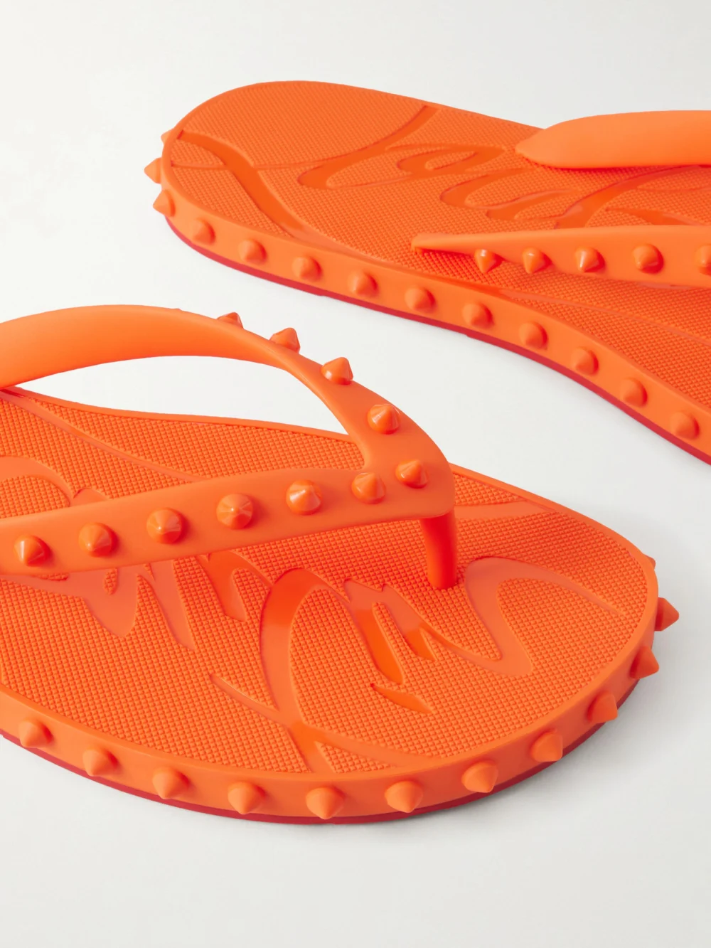 Close-up detail of the Christian Louboutin Super Loubi Studded Rubber Flip Flops
