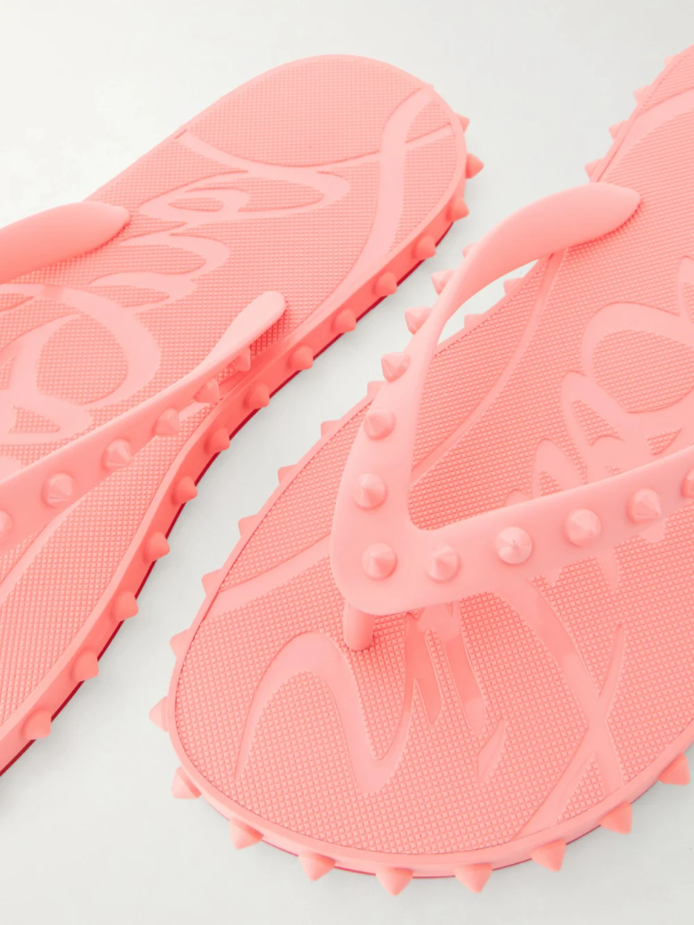 Close-up detail of the Christian Louboutin Super Loubi Studded Rubber Flip Flops