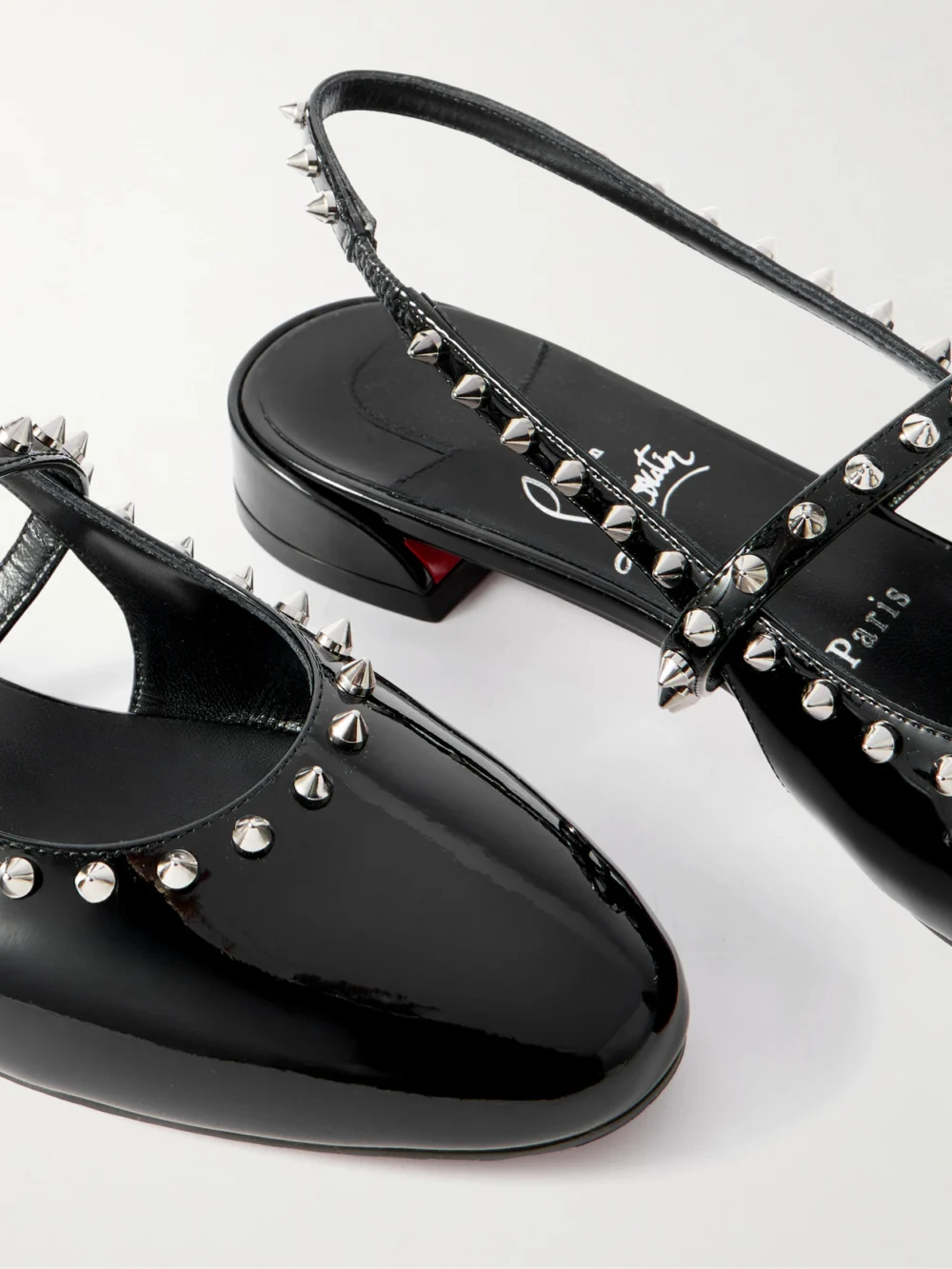 Close-up detail of the Christian Louboutin Sweet Janispikes Studded Patent-leather Slingback Flats