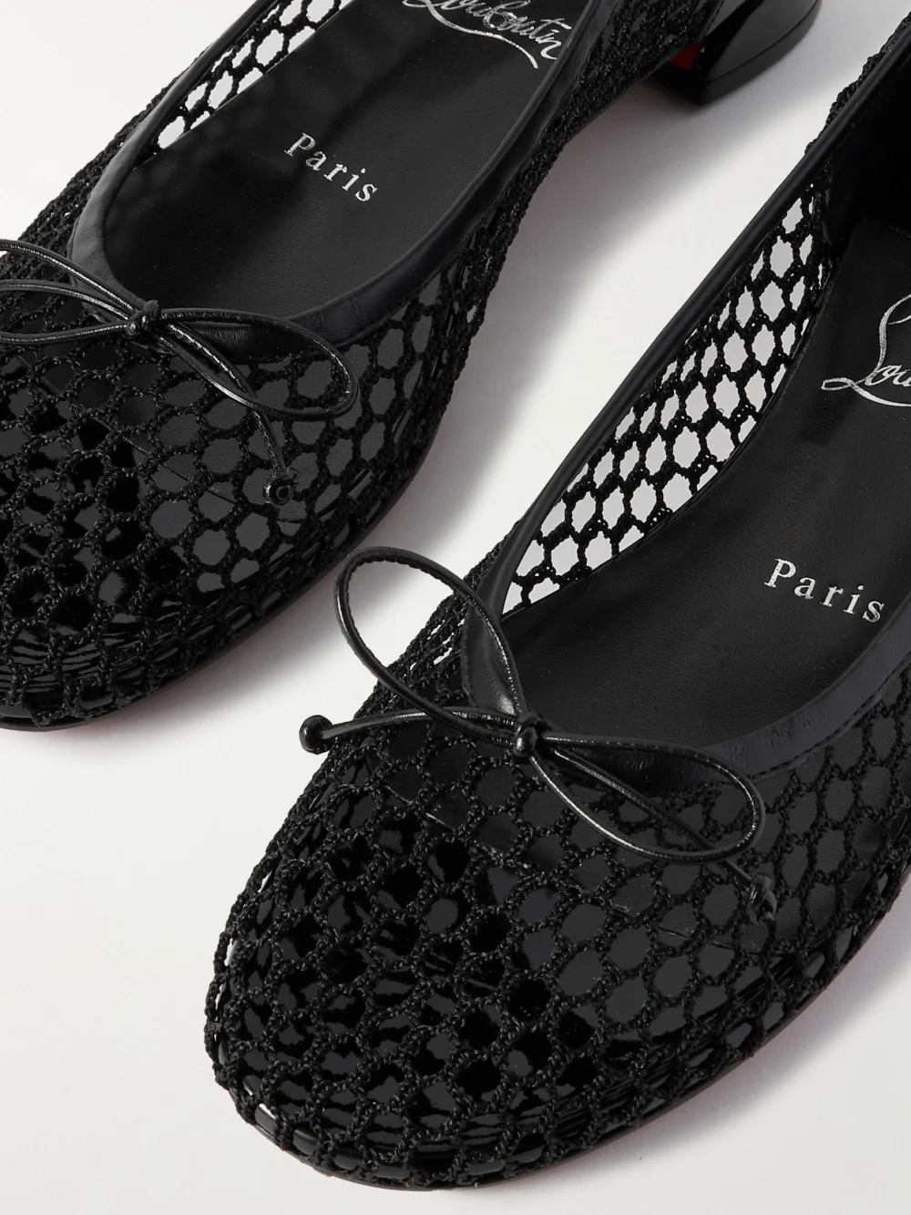 Close-up detail of the Christian Louboutin Sweetie Jane 20 Patent Leather-trimmed Fishnet Ballet Flats